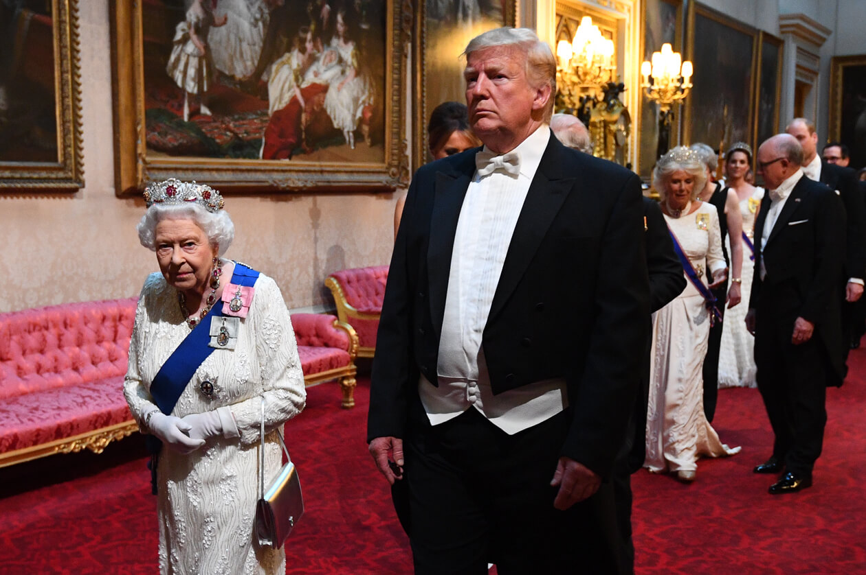 Donald Trump in a formal tuxedo, walking with the Queen of England.
