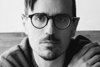 Man wearing glasses wearing a sweater