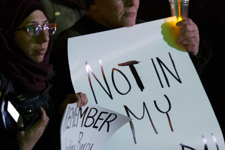 Photograph of Women Holding Signs at a Vigil