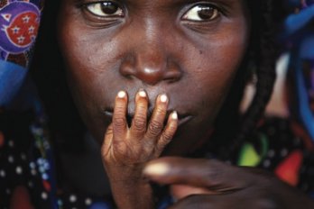 Woman with child's hand over her face