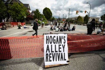 A photo of a sign on a street barricade that says “Hogan’s Alley Revival” at a 2020 Black Lives Matter protest in Vancouver.