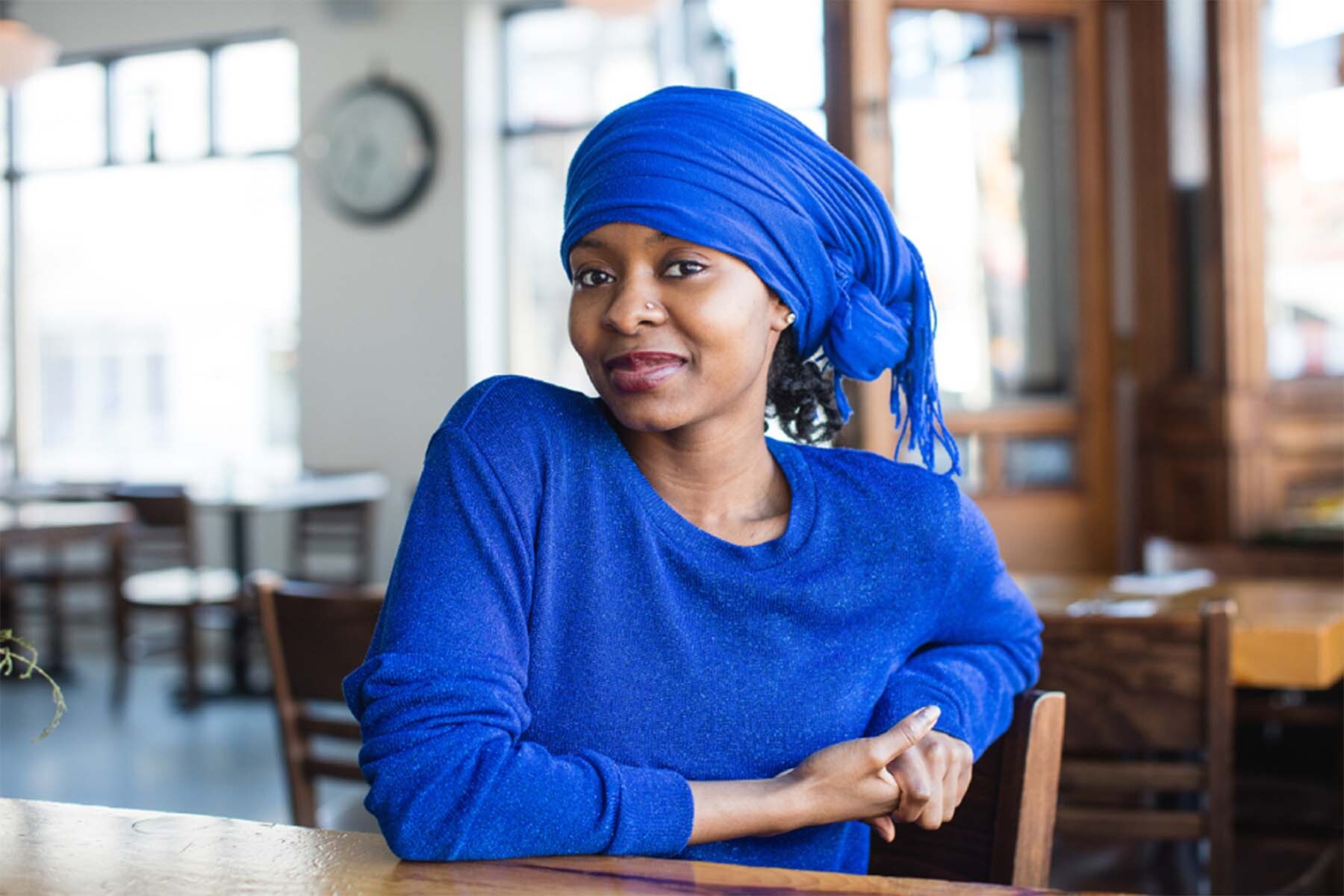 Habiba Cooper Diallo wearing blue and sitting at a table.