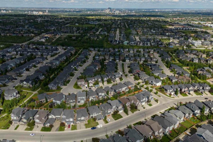Photo looking down at a suburb with rows full of single-detached houses.