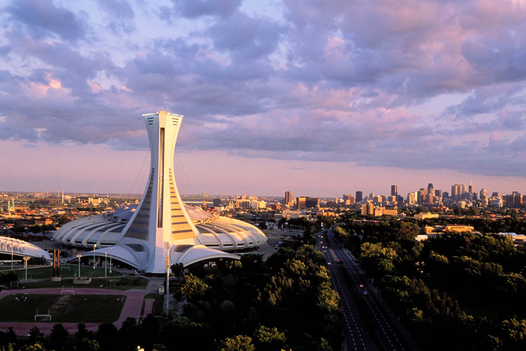 A skyline photo of Montreal with the Olympic Stadium in the foreground.