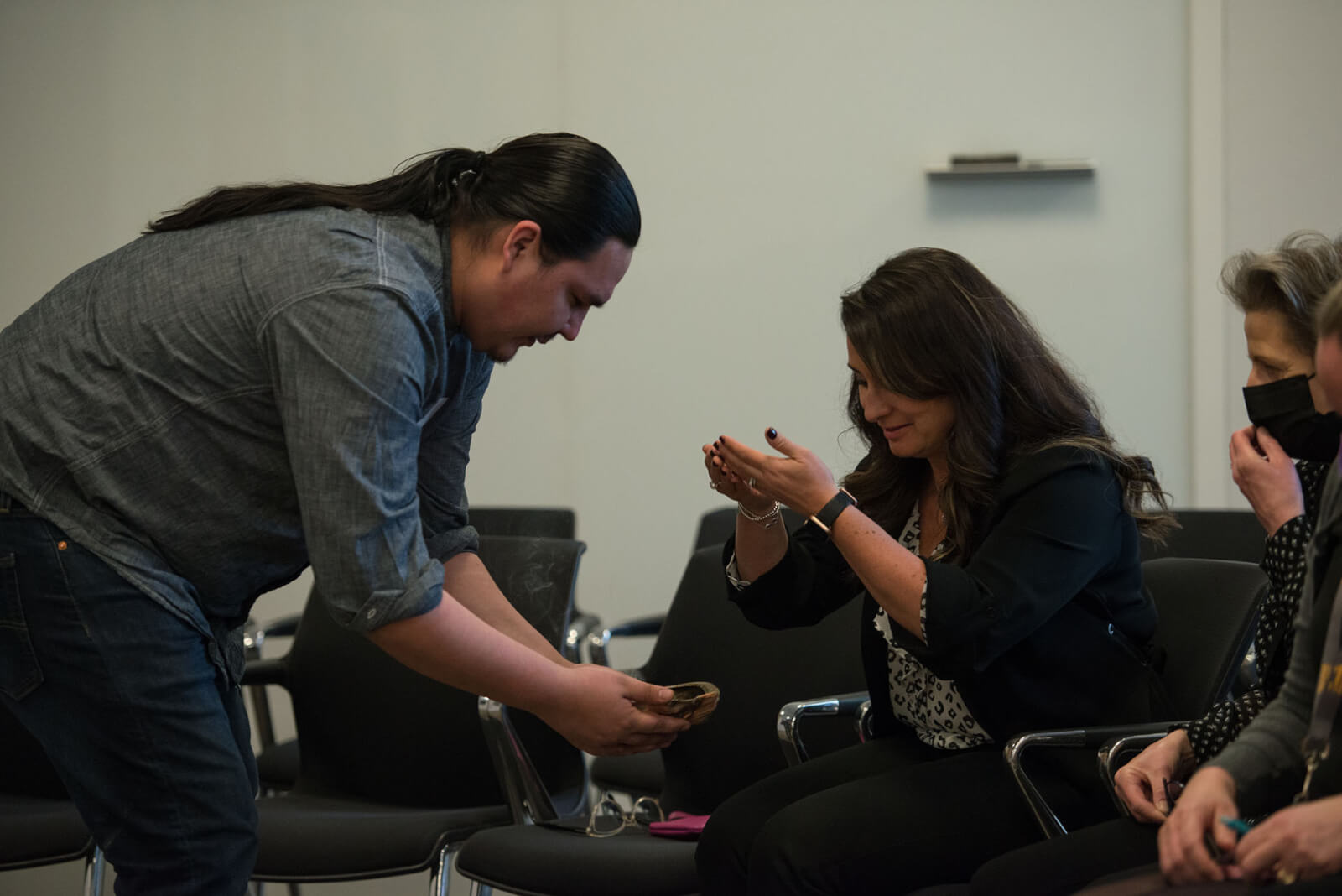 A member of the Tsuu T’ina Nation west of Calgary conducts a smudge ceremony with members of Enbridge’s Indigenous Employee Resource Group.