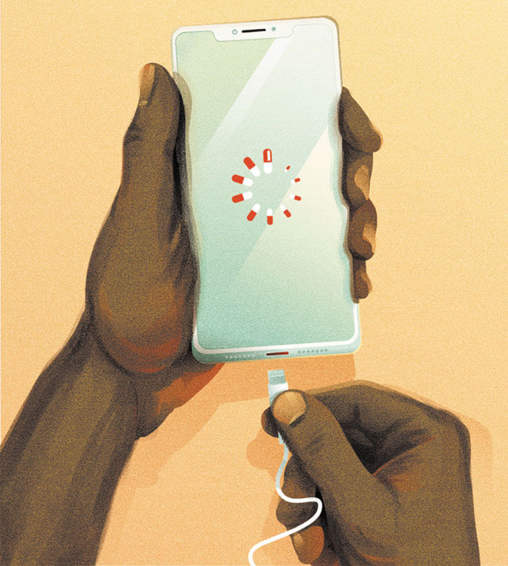 A pair of hands plugs a cable into an iPhone. The phone's loading screen displays a circle of pill capsules.