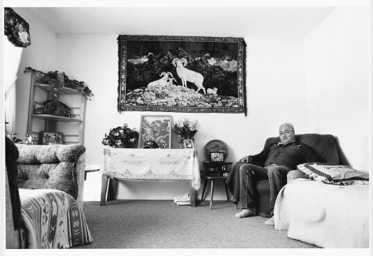 August Brown sits in the living room of his Telegraph Creek home. Brown worked as a ranch hand for a big-game outfitter for most of his life.