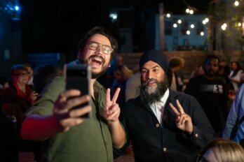 New Democratic Party Leader Jagmeet Singh, right, poses for a selfie while greeting supporters at an event during the NDP caucus retreat in Halifax on Thursday, September 8, 2022.