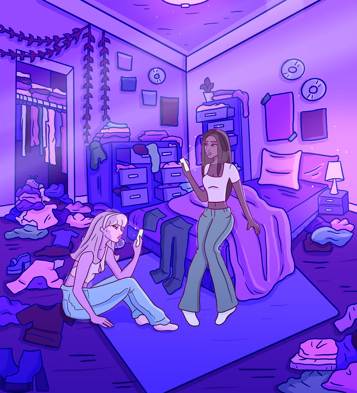 Two teens stare at their phones surrounded by clothes.