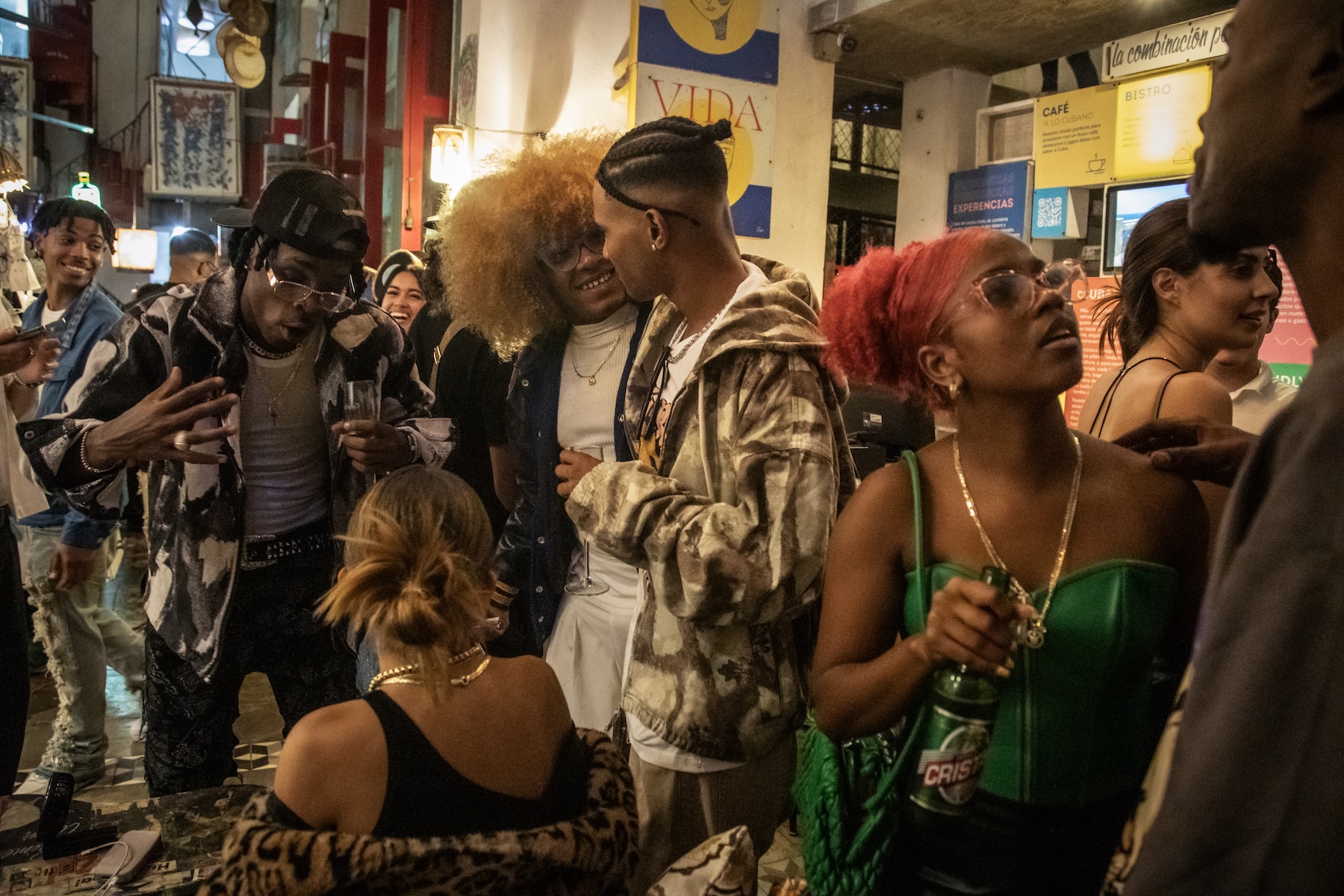 Photo of a crowd of young people socializing together.