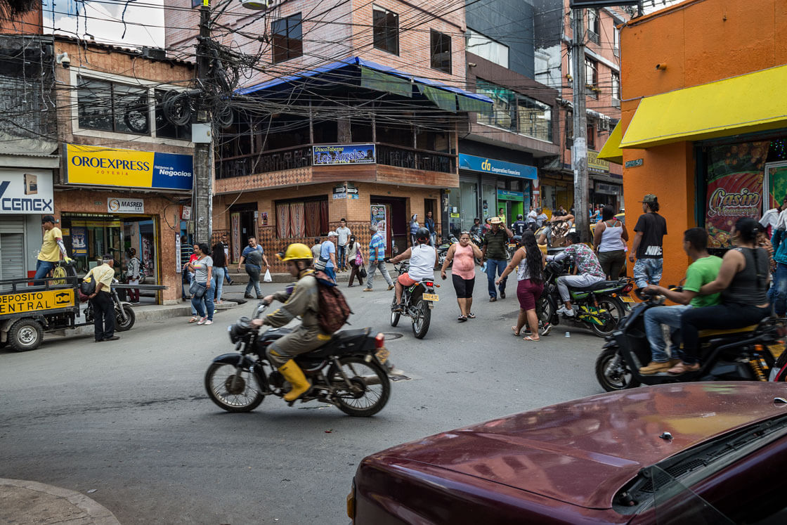 A miner on a bike speeds through an intersection near the central plaza.