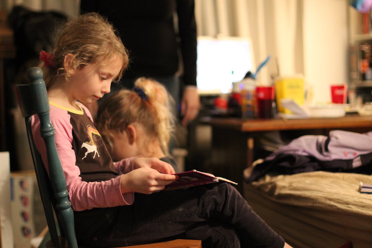 Andrea reads her library book at home in Princess Place