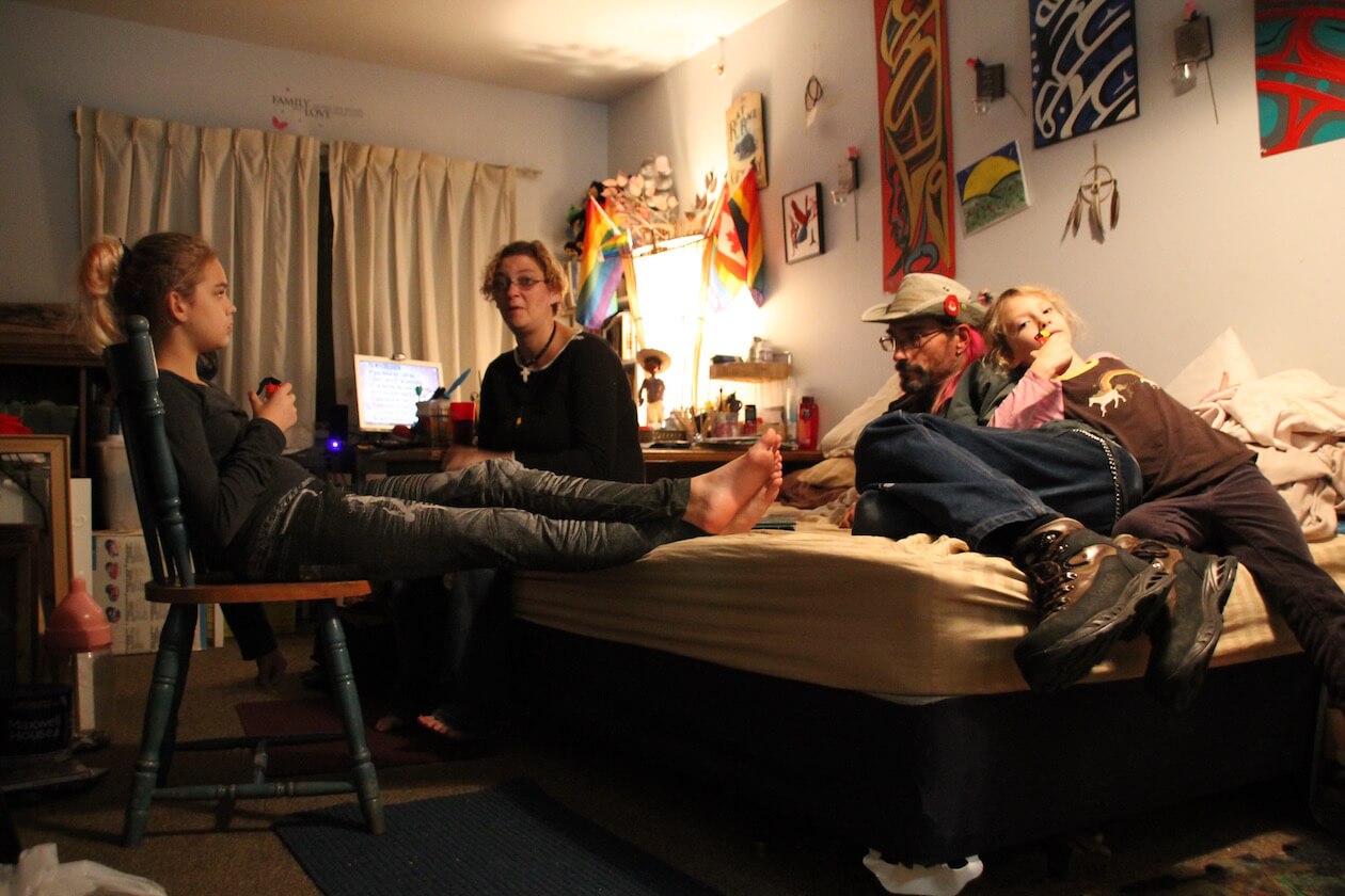 The family in the living room of their Princess Place apartment