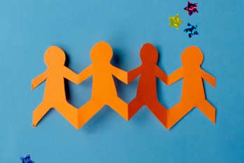 cutout of four purple on a blue backdrop
