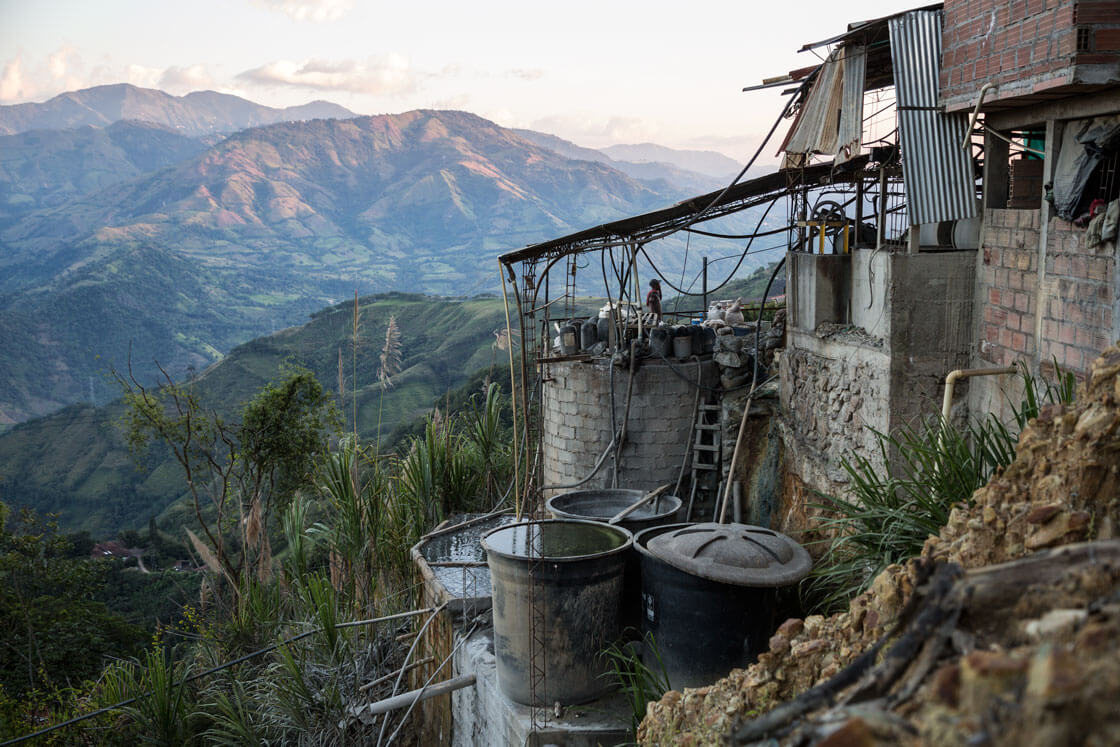 An ore refinery sits on a mountainside.