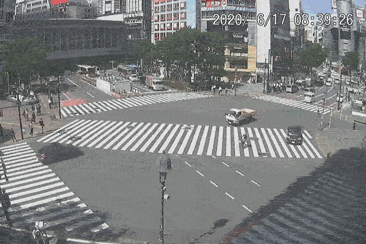 A gif of the webcam trained on Tokyo's Shibuya Crossing, a crosswalk that is much less densely populated by pedestrians and cars than it usually is.