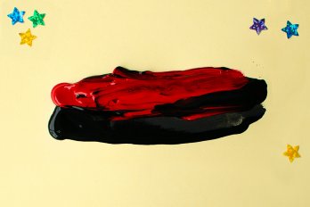 red and black paint streaks on a yellow backdrop