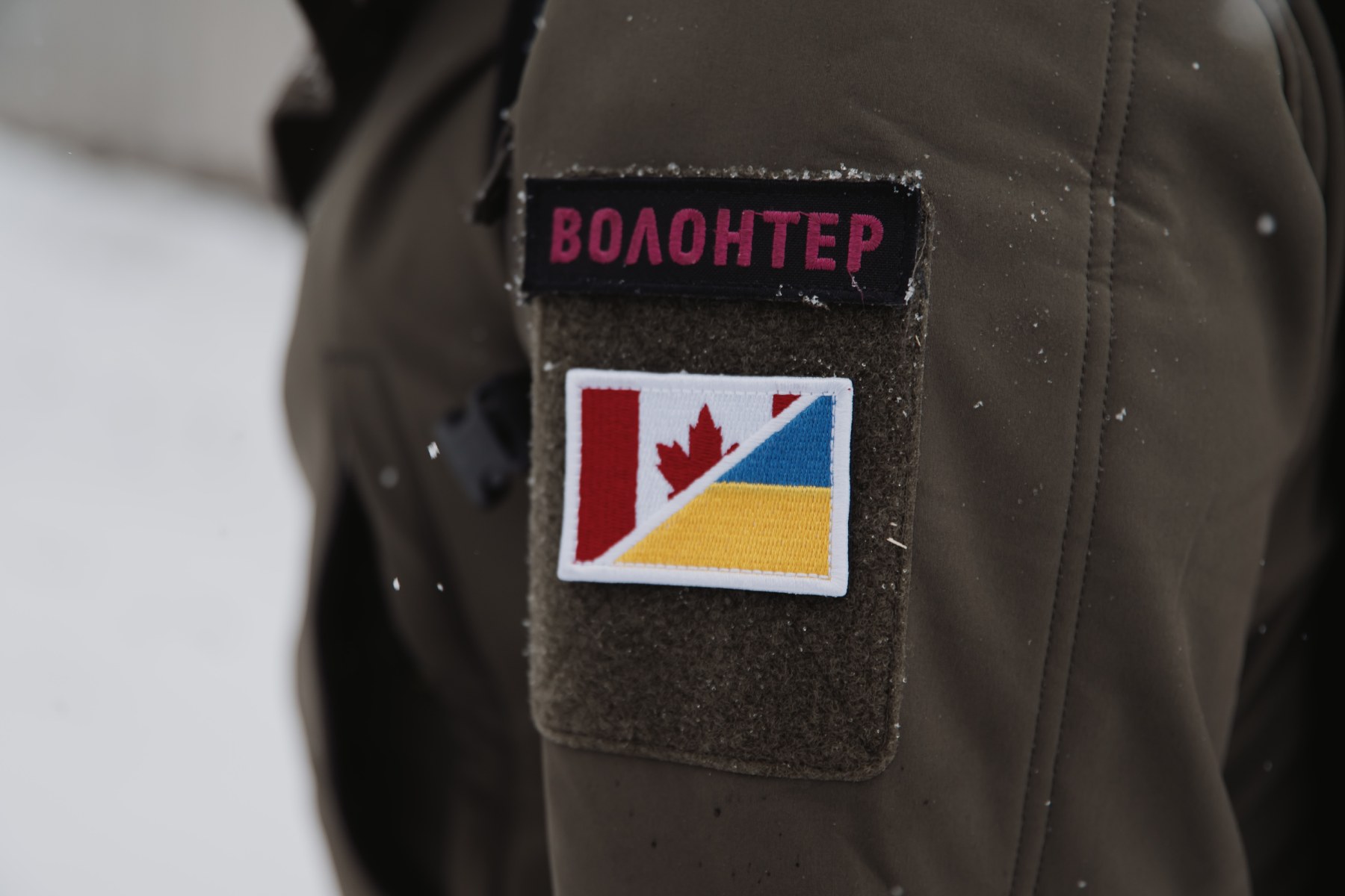 Close-up photo of an arm patch with Ukrainian writing that reads 