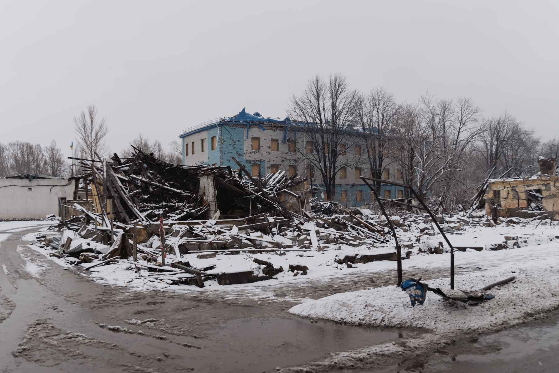 Photo of the remains of a destroyed building in the snow.