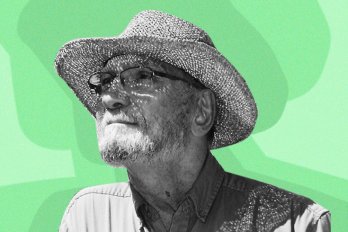Photo of the poet, George Amabile, wearing a sun hat and looking toward the sky. The photo is in black and white; the background is various shades of green.