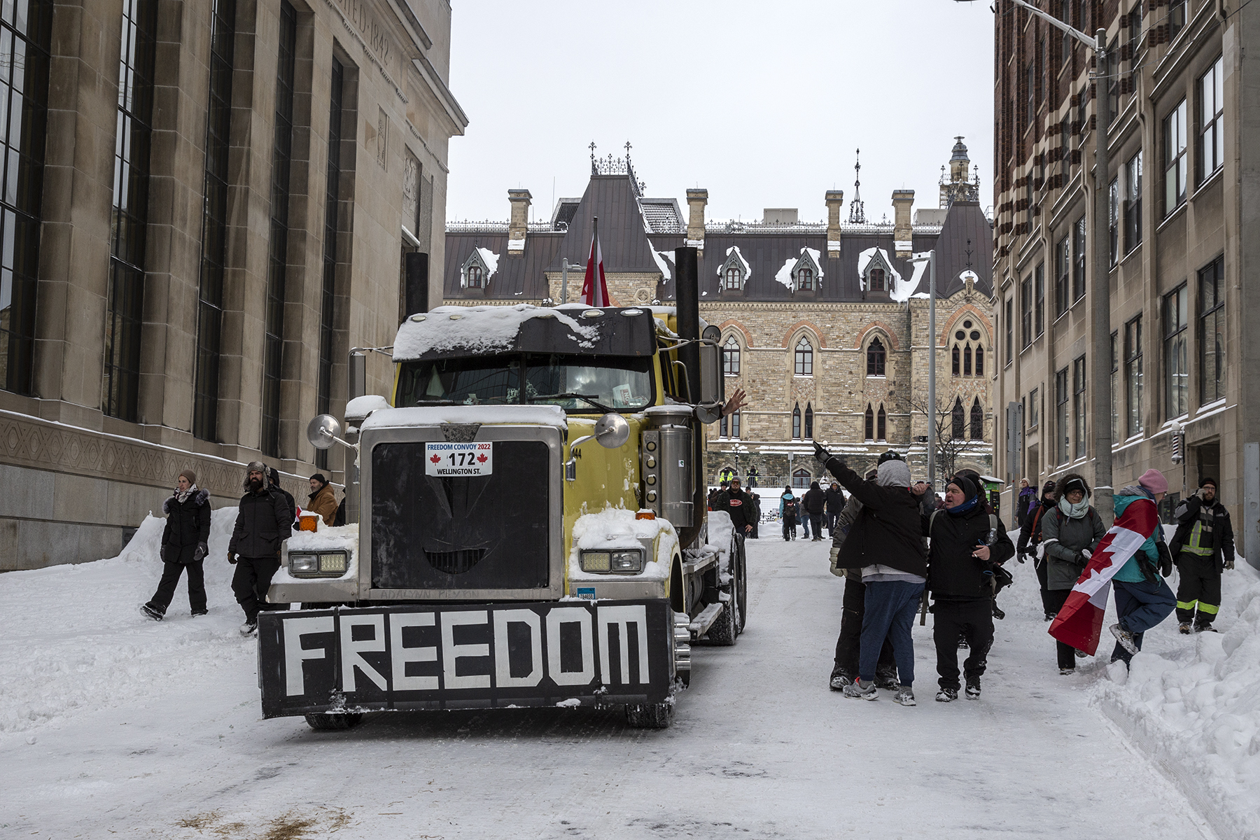 A truck driver waves to other protesters on a snowy street in Ottawa
