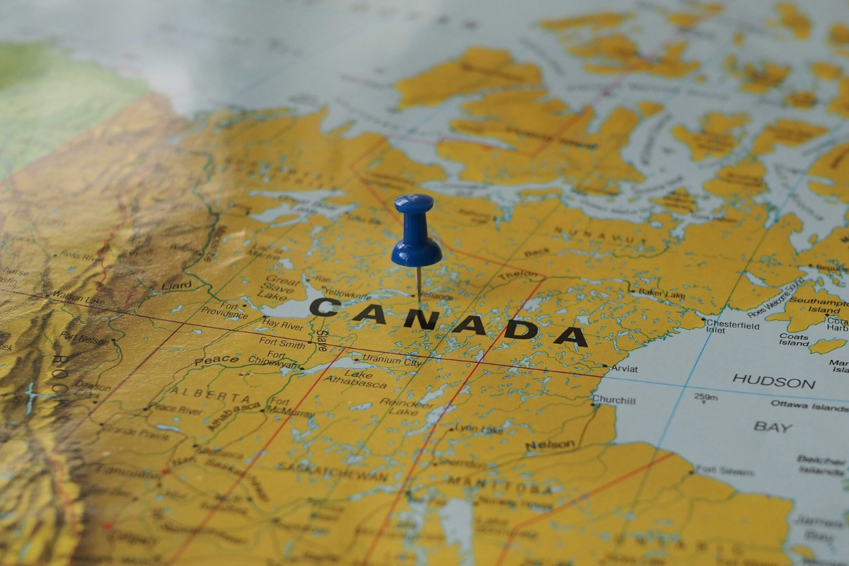 An image shows Canada on the map with a pin in it