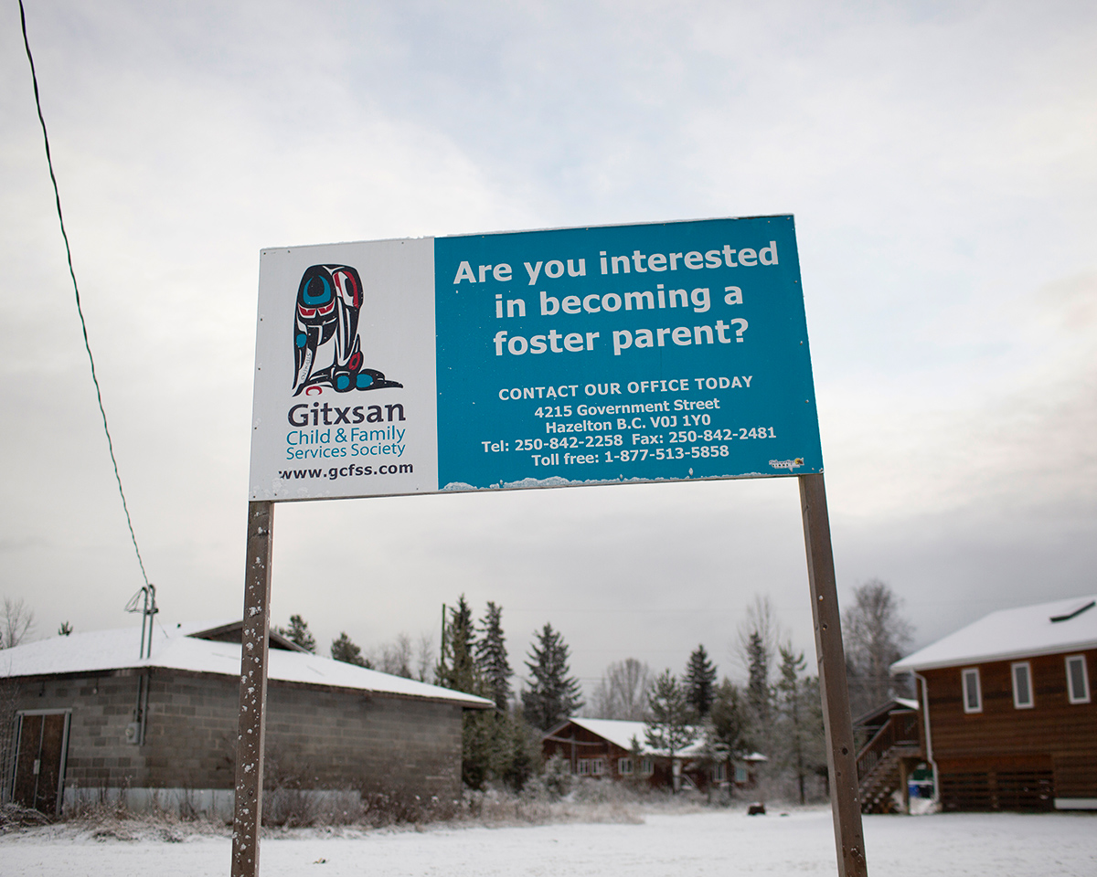 A sign outside houses in the community of Anspayaxw reads 