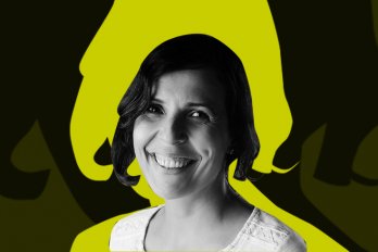 A photo of the poet, who is smiling at the camera and has short, dark hair. Behind her is a lime-green and black background.