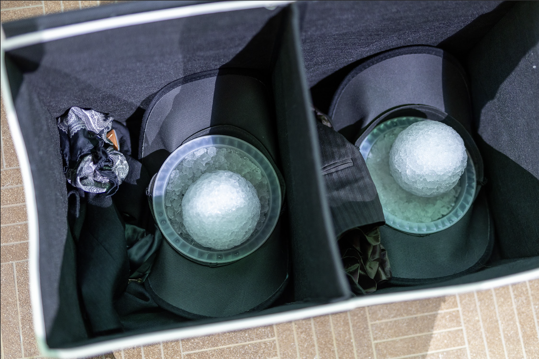 Photo of a fabric storage container. Inside are cowboy hats containing snowballs.