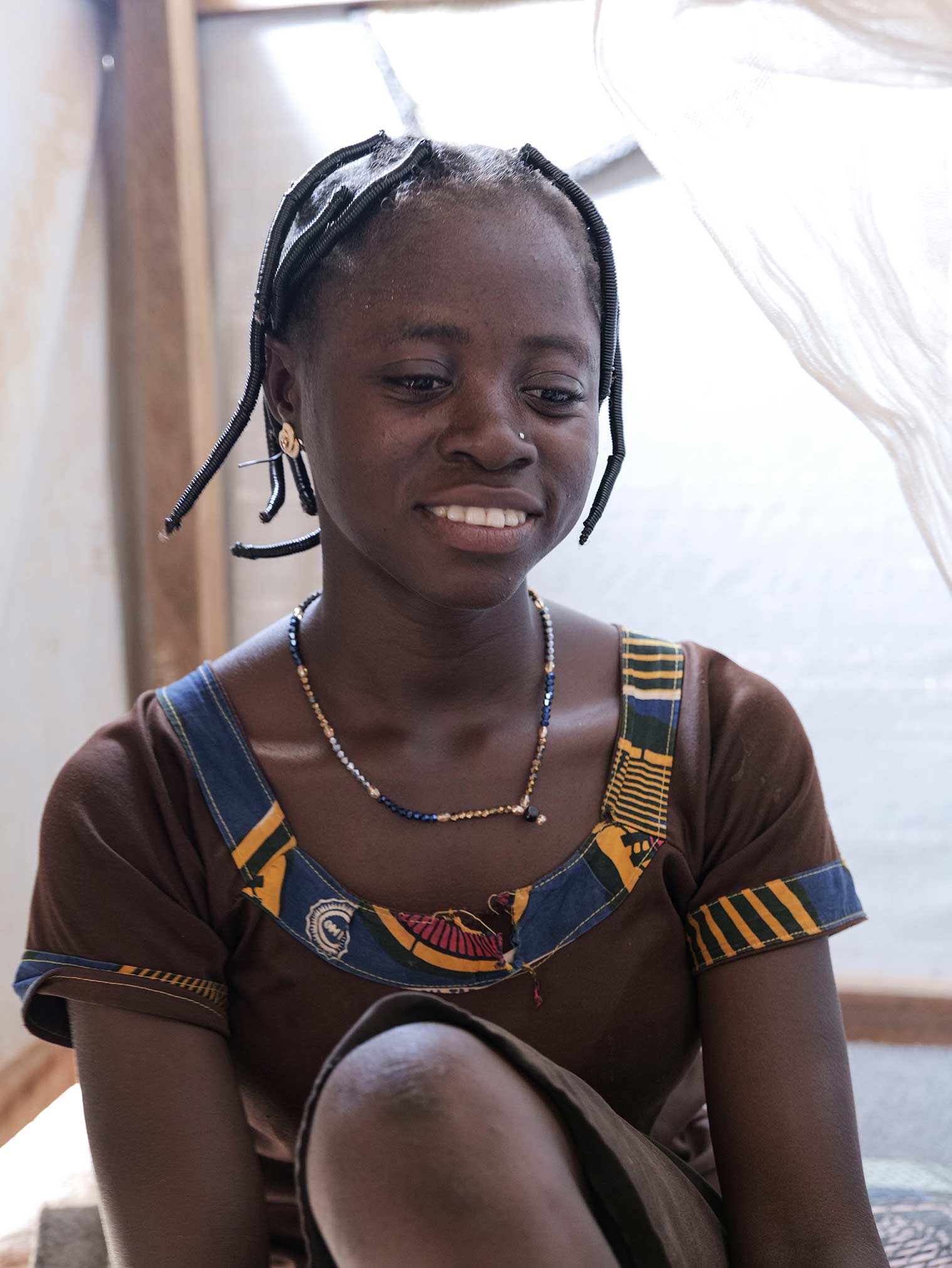 A portrait of “Samira,” aged 15, inside her home in a settlement in Yatenga province, Burkina Faso.