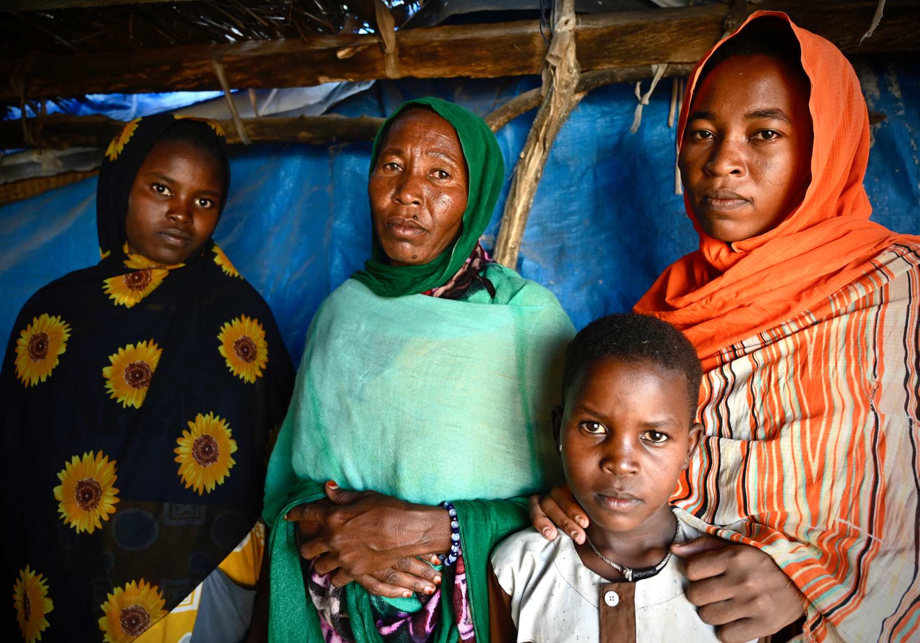 Photograph of four women in headscarves with a young child.