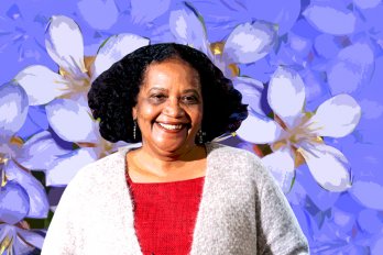 Photo of the poet Lorna Goodison against a violet floral backdrop