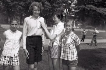 A black and white photo shows four school-aged girls posing for the camera, with the writer Susan Swan, second from left, standing significantly taller than the rest