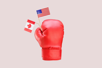 A photo illustration shows a boxing glove holding a US and a Canadian flag, with the Canadian flag bent to one side