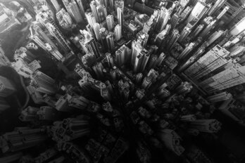 Black and white photo of a skyscraper filled city from directly above.