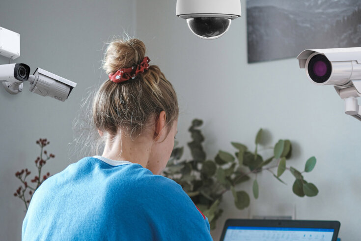 Photo of a woman on a computer. In the top of the image, three security ...
