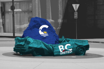 A large blue rock with the BC Conservative logo on it crushes a teal car with the BC United logo on it.