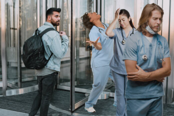 A photo illustration showing nurses going through a revolving door