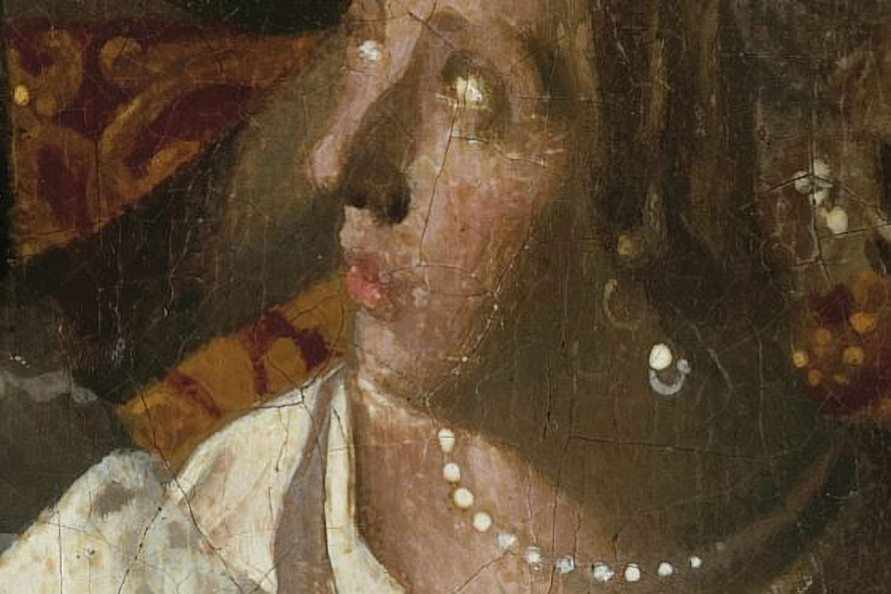 A vermeet painting of a woman wearing pearls looking to her right.