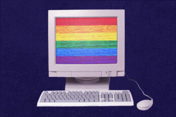 Image of a vintage, white desktop computer displaying a rainbow flag on a dark blue background.