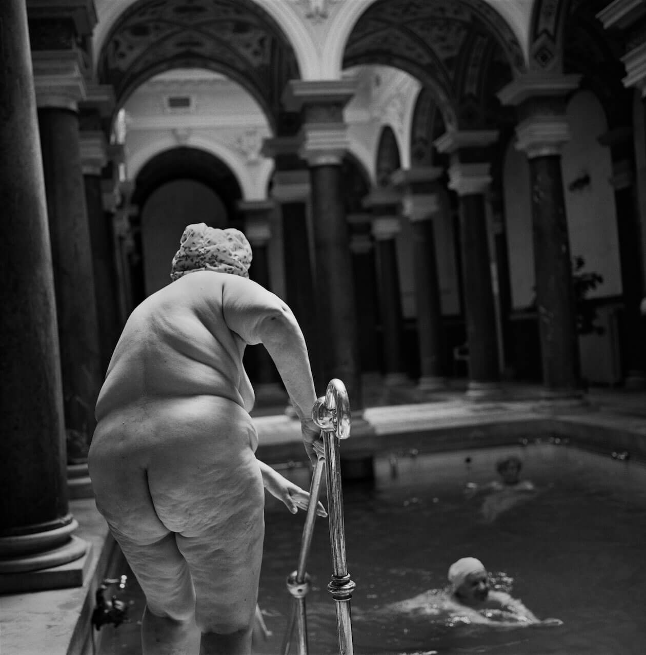 Woman entering mineral pool