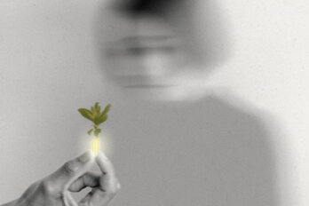 A black and white photo illustration shows the blurry image of a woman and a hand holding a shining pill with a bunch of leaves coming out of it