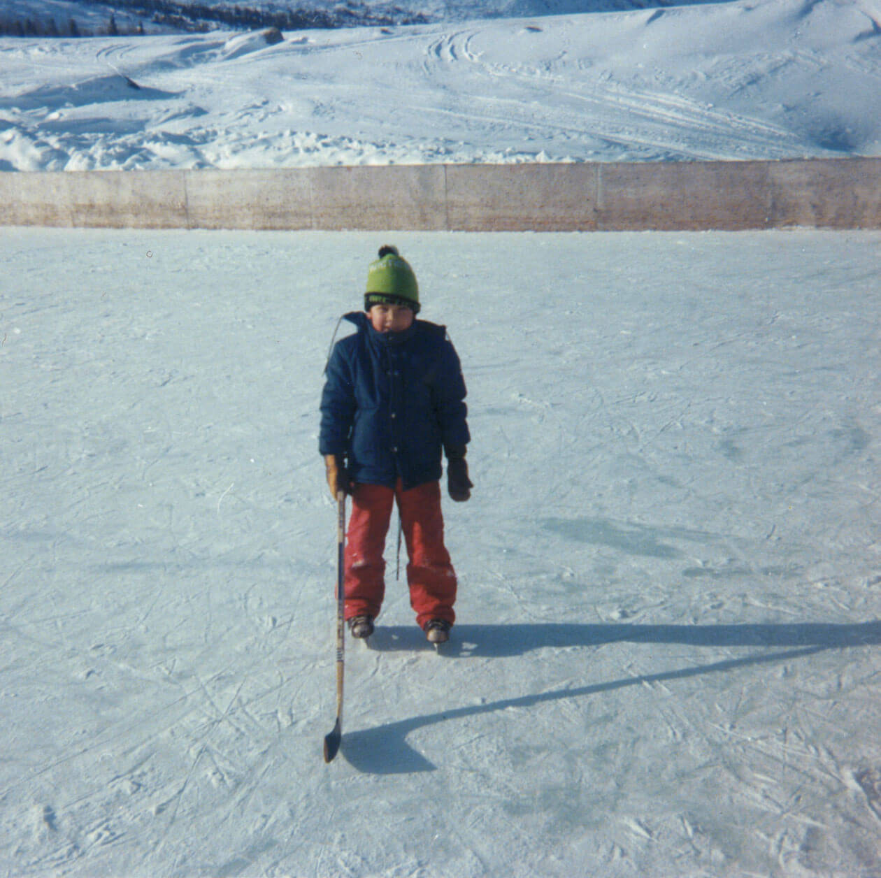 Childhood photo of Obed playing hockey outside