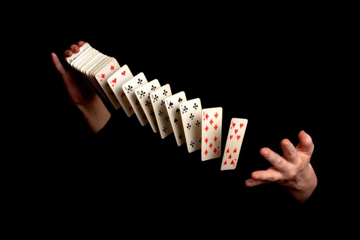 hands throwing and shuffling playing cards