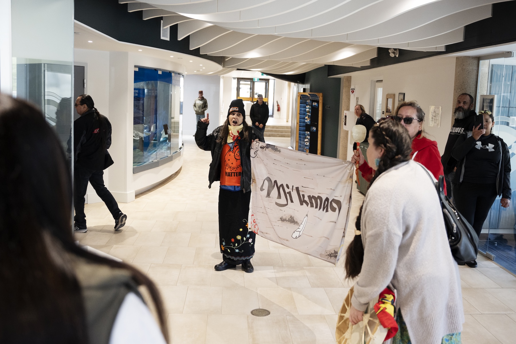 Photo of people holding a banner that reads "Mi'kmaq."