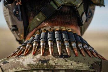 A soldier of the 41 Canadian Brigade Group carries ammunition for a C9 squad automatic weapon during training at CFB Suffield, Alta.