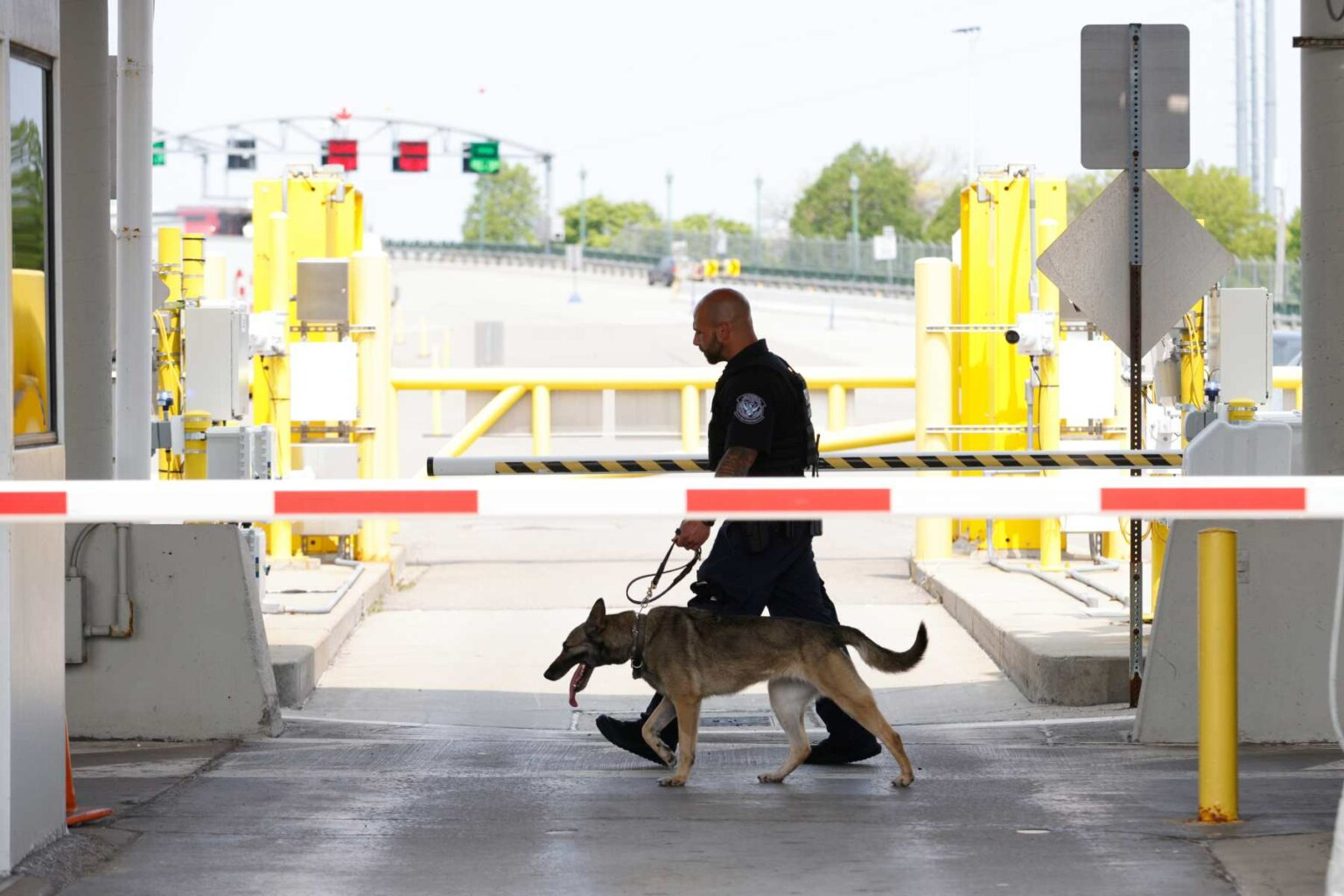 A US Customs and Border Protection officer canine unit searches vehicles at the Peace Bridge Port of Entry in Buffalo, New York.