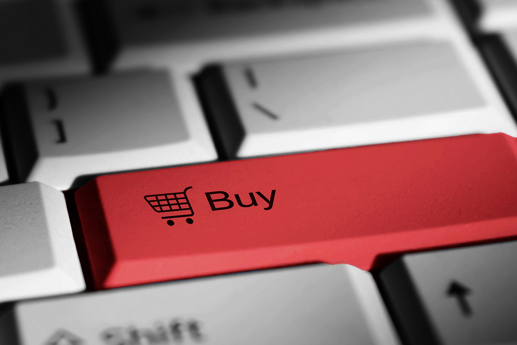 Close up photo of a keyboard with a red "Enter" key; instead of enter, the key reads "Buy" with a small icon of a shopping cart.