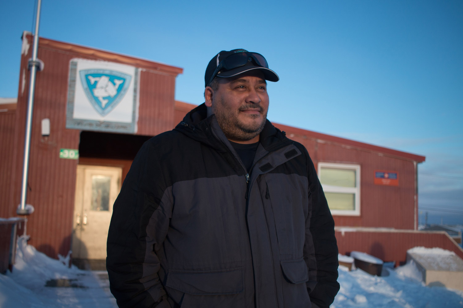 A man stands in front of a building