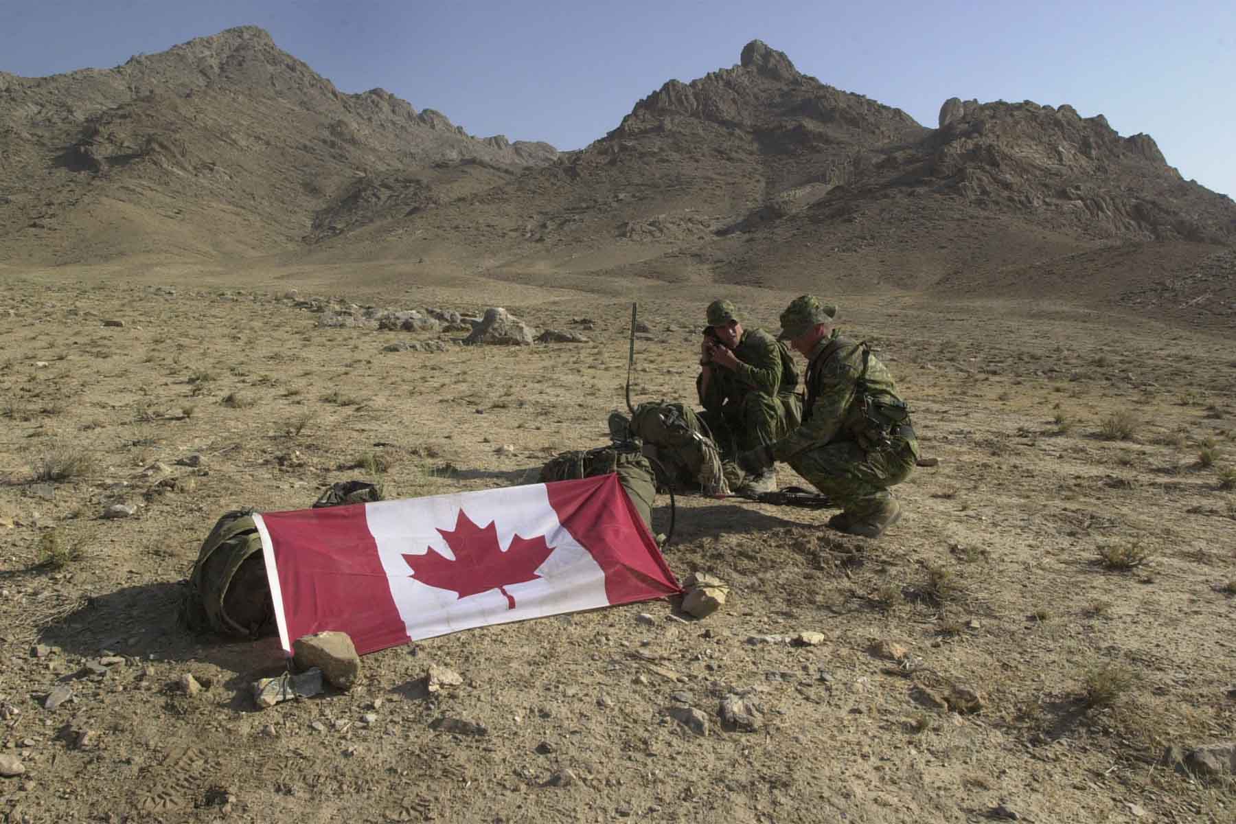 A 2002 photo of Canadian soldiers in Afghanistan with the Canadian flag.